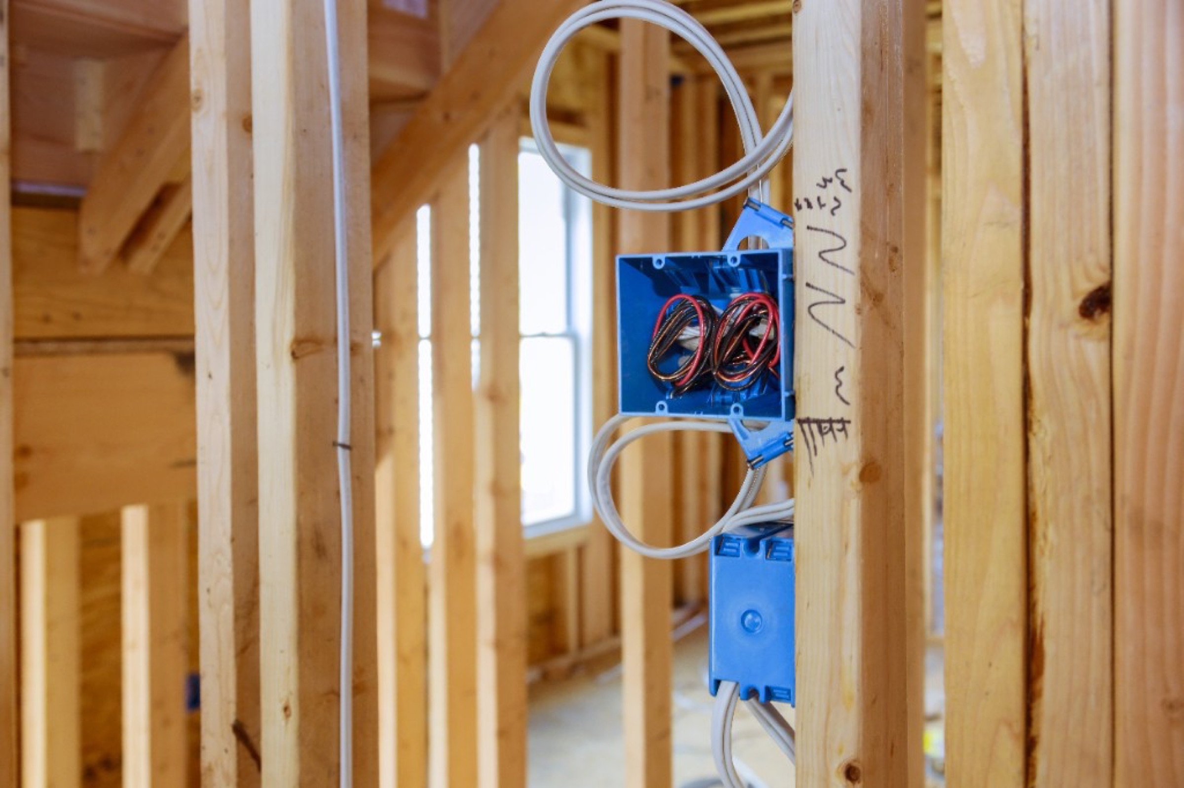 Electrical boxes and wiring roughed in on new construction framing