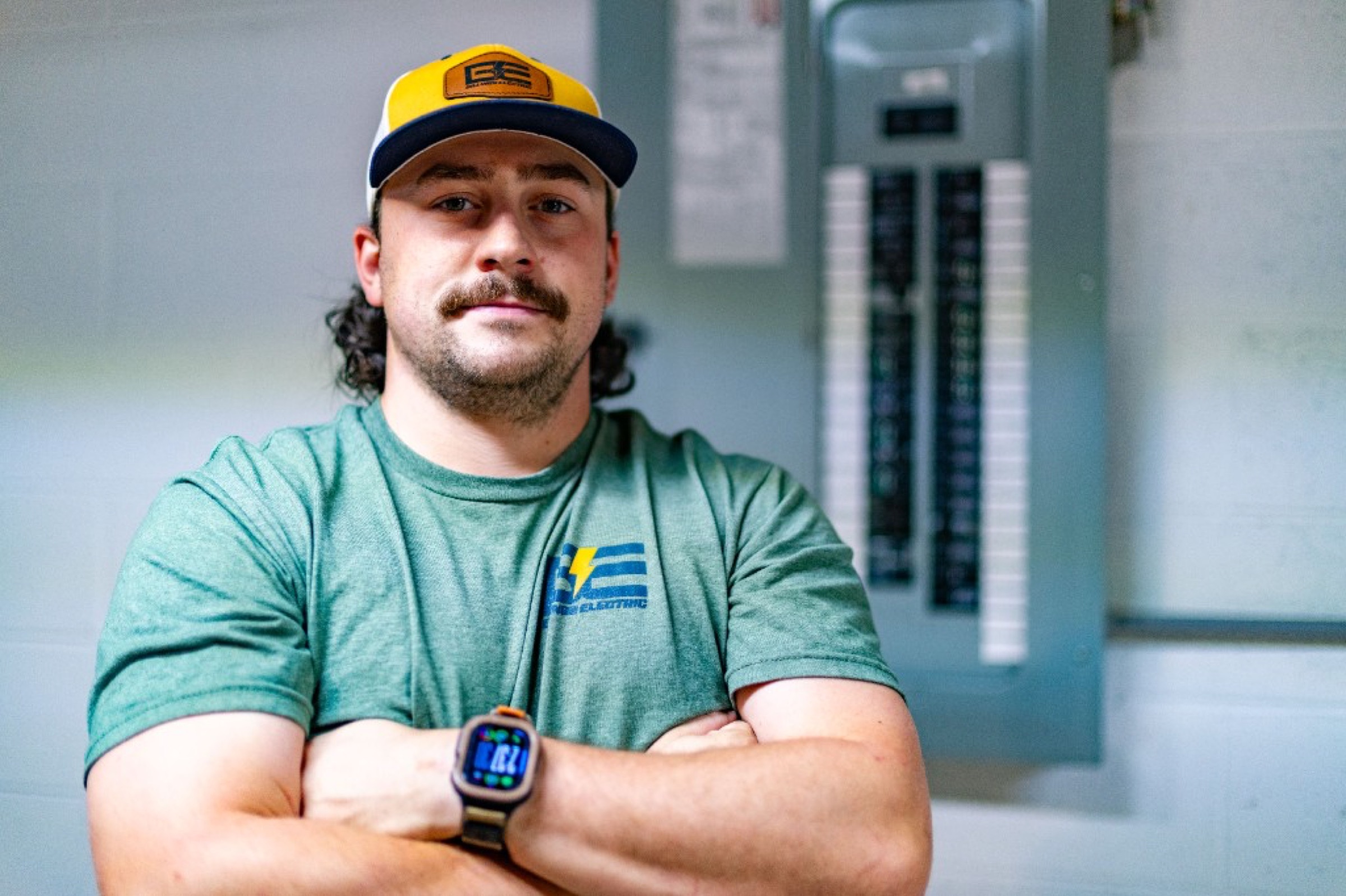 Hunter Billings, licensed electrician, at a service panel